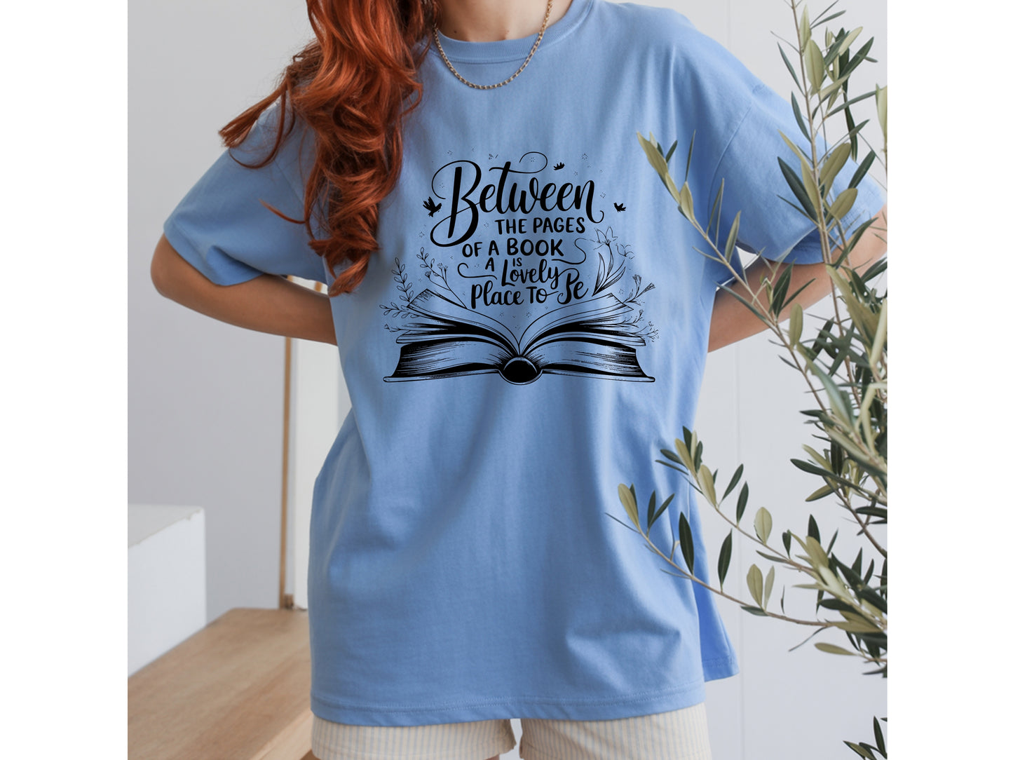 "Between the Pages of a Book Is a Lovely Place to Be" — Floral Literary Graphic Tee | Gift for Readers