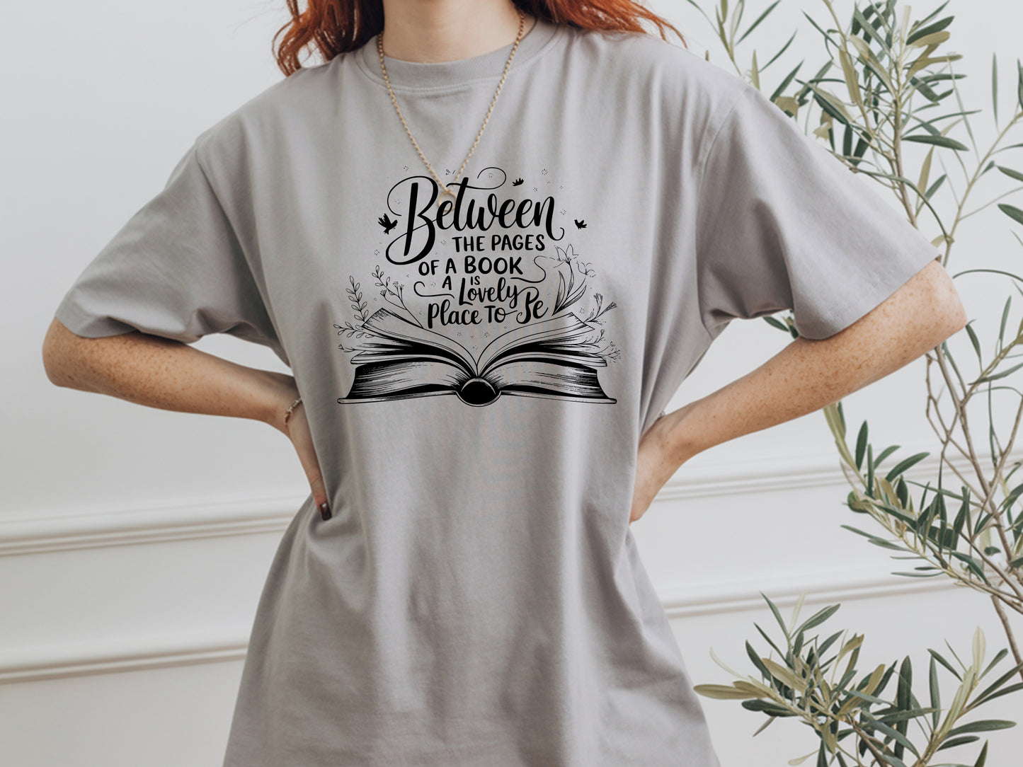 "Between the Pages of a Book Is a Lovely Place to Be" — Floral Literary Graphic Tee | Gift for Readers