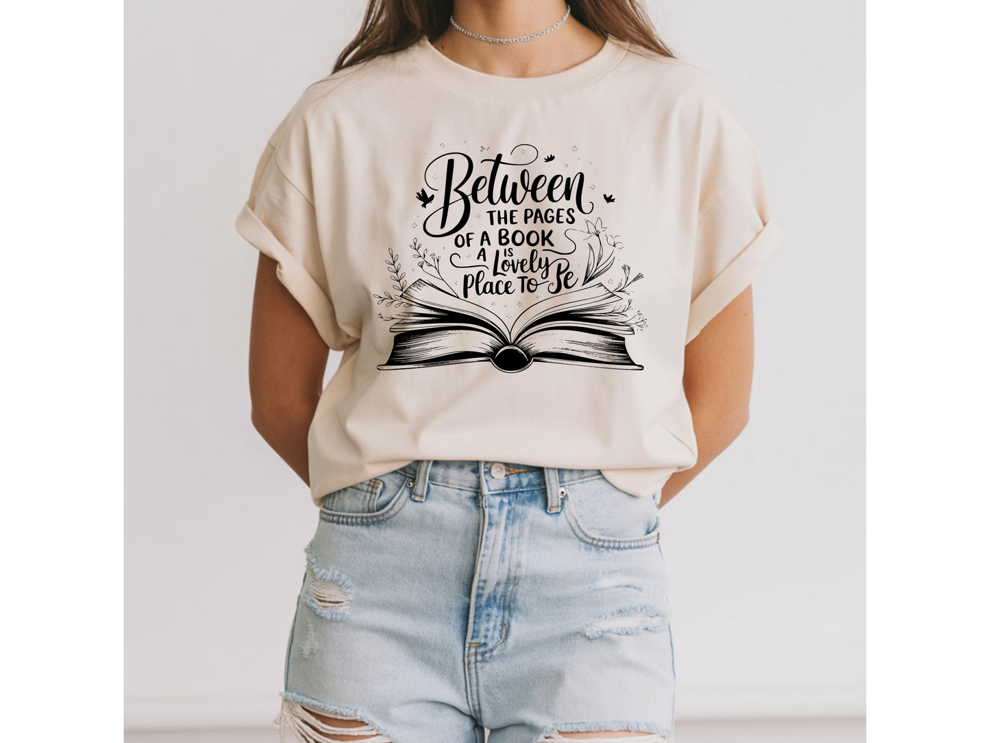 "Between the Pages of a Book Is a Lovely Place to Be" — Floral Literary Graphic Tee | Gift for Readers